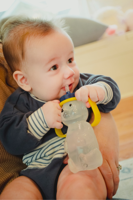 Toddler drinking from the Honey Bear Straw Cup during feeding therapy